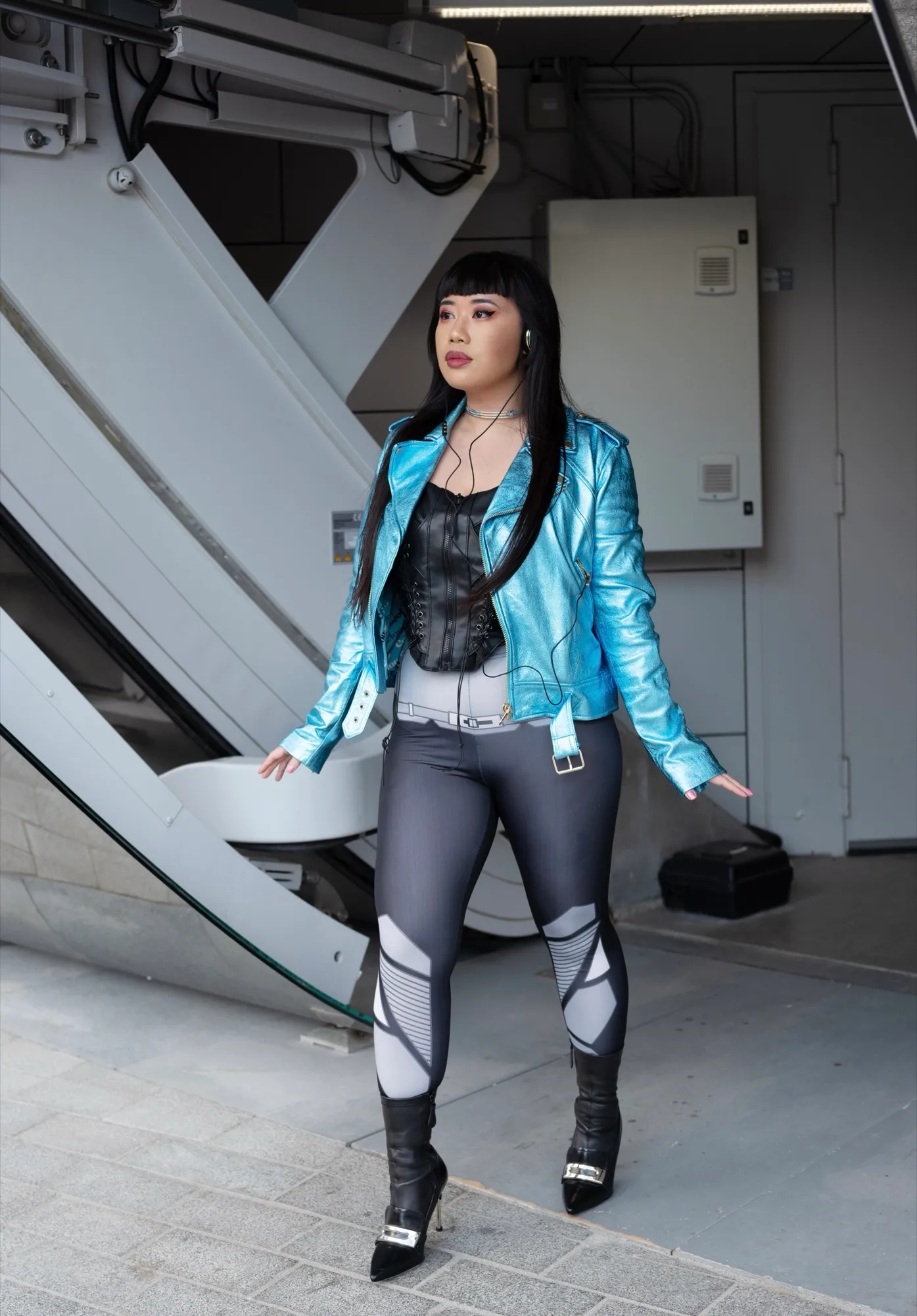Walking through an industrial space in a metallic blue jacket, for Concrete Store